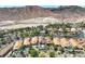 Stunning aerial view of a community in the mountains, with palm trees and landscaping surrounding the homes at 12 Via Ravello, Henderson, NV 89011