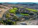 Expansive aerial view of the community featuring a golf course, a lake, and winding roads at 12 Via Ravello, Henderson, NV 89011