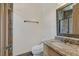 Powder bathroom featuring a granite countertop, custom mirror, and tiled accent wall at 12 Via Ravello, Henderson, NV 89011