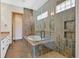 Gorgeous bathroom with a glass-enclosed shower, soaking tub, and tiled accent walls at 12 Via Ravello, Henderson, NV 89011