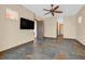 Spacious bedroom featuring decorative stone flooring, ceiling fan, and neutral wall paint at 12 Via Ravello, Henderson, NV 89011