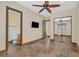 Bedroom with decorative ceiling fan, recessed lighting, and ensuite bathroom with a large closet and beautiful floor tiles at 12 Via Ravello, Henderson, NV 89011