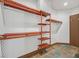Walk-in closet with custom shelving and decorative stone flooring at 12 Via Ravello, Henderson, NV 89011