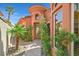 Elegant home entrance featuring a turret accent, a curved walkway, lush landscaping, and a stylish front door at 12 Via Ravello, Henderson, NV 89011