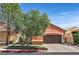 Charming home with a two-car garage, tree in the front, and a well-manicured lawn in a lovely community at 12 Via Ravello, Henderson, NV 89011