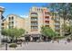 Multi-story building with balconies and outdoor dining space, surrounded by lush landscaping at 12 Via Ravello, Henderson, NV 89011