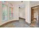 Hallway with tile flooring, natural light, and views into the laundry room at 12 Via Ravello, Henderson, NV 89011