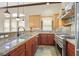 Kitchen features stainless steel appliances, custom backsplash, granite countertops, and wooden cabinets at 12 Via Ravello, Henderson, NV 89011