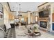 Living room with stone fireplace open to kitchen, modern furnishings and decor at 12 Via Ravello, Henderson, NV 89011