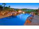 Picturesque pool area with mature desert landscaping and an inviting spa; perfect for relaxation at 12 Via Ravello, Henderson, NV 89011