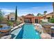 Stunning pool features rock accents and water bowls cascading into the refreshing, turquoise water at 12 Via Ravello, Henderson, NV 89011
