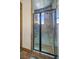 Modern shower with stone-look tile, black framed glass door, and a built in bench adds to the bathroom's luxe feel at 12 Via Ravello, Henderson, NV 89011