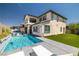 Private backyard features a pool, patio area, artificial grass, and a covered outdoor living space at 12024 Girasole Ave, Las Vegas, NV 89138