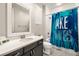 Bathroom featuring a shower-tub combination and a single sink vanity with a decorative mirror at 12024 Girasole Ave, Las Vegas, NV 89138