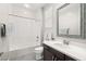 Bright bathroom featuring a shower-tub combination and a single sink vanity with a decorative mirror at 12024 Girasole Ave, Las Vegas, NV 89138