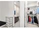 Pass through view of a bathroom and closet, with gray tiling and neutral colors at 12024 Girasole Ave, Las Vegas, NV 89138