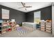 bedroom with dark accent wall, neutral carpet, and storage shelves at 12024 Girasole Ave, Las Vegas, NV 89138