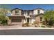 Charming two-story home with brick accents, a two-car garage, and beautifully landscaped front yard at 12024 Girasole Ave, Las Vegas, NV 89138