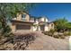 Beautiful home with a brick driveway, two-car garage, and a well-manicured front yard with mature trees at 12024 Girasole Ave, Las Vegas, NV 89138