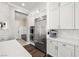 Bright kitchen showcases stainless steel refrigerator and oven, with white cabinetry and a herringbone backsplash at 12024 Girasole Ave, Las Vegas, NV 89138