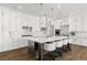 Modern kitchen features white cabinets, stainless steel appliances, a large island, and stylish pendant lighting at 12024 Girasole Ave, Las Vegas, NV 89138