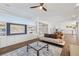 Spacious living room with a custom built-in unit, hardwood floors, and large windows for ample natural light at 12024 Girasole Ave, Las Vegas, NV 89138