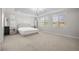 Spacious and brightly lit main bedroom with neutral color scheme, large windows, and plush carpet at 12024 Girasole Ave, Las Vegas, NV 89138