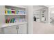 An office area with built in bookshelves and cabinets in neutral colors and light carpet at 12024 Girasole Ave, Las Vegas, NV 89138