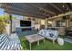 Relaxing outdoor space with covered patio, a fireplace, TV, and comfortable seating, ideal for entertaining and enjoying outdoor living at 12024 Girasole Ave, Las Vegas, NV 89138