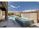 Beautiful backyard showcasing a sparkling pool with a waterfall feature, creating a serene and luxurious outdoor oasis at 12024 Girasole Ave, Las Vegas, NV 89138