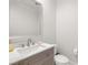 Clean powder room featuring modern sink, vanity, brushed nickel faucet, and bright lighting at 12024 Girasole Ave, Las Vegas, NV 89138