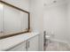 Elegant powder room featuring a decorative mirror, vanity with storage, and modern fixtures at 12024 Girasole Ave, Las Vegas, NV 89138