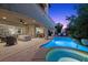 Backyard oasis featuring a sparkling pool, spa, and covered patio, creating a perfect outdoor entertaining and relaxation space at 12125 Edgehurst Ct, Las Vegas, NV 89138