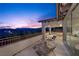 Balcony seating with a beautiful night view of the landscape, sky, and neighboring houses at 12125 Edgehurst Ct, Las Vegas, NV 89138