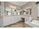 Elegant bathroom with dual sinks, a large mirror, soaking tub and decorative accents at 12125 Edgehurst Ct, Las Vegas, NV 89138