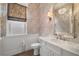 Charming powder room with patterned wallpaper, marble countertop, and elegant lighting at 12125 Edgehurst Ct, Las Vegas, NV 89138