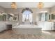 Luxurious bathroom featuring a soaking tub, elegant fixtures, and abundant natural light at 12125 Edgehurst Ct, Las Vegas, NV 89138