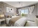 Cozy bedroom with stylish decor, a brick accent wall, and plenty of natural light at 12125 Edgehurst Ct, Las Vegas, NV 89138