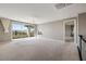 Spacious bonus room with sliding glass doors to a balcony and neutral carpet at 12125 Edgehurst Ct, Las Vegas, NV 89138