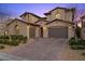 Elegant exterior showcasing a spacious three-car garage, paver driveway, and tasteful landscaping at 12125 Edgehurst Ct, Las Vegas, NV 89138