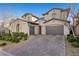 Stunning home exterior boasting a three-car garage, paver driveway, and immaculate landscaping at 12125 Edgehurst Ct, Las Vegas, NV 89138