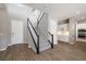 Bright foyer featuring hardwood floors, a staircase with black railings, and an open layout at 12125 Edgehurst Ct, Las Vegas, NV 89138