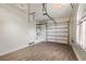 Bright, well-lit garage with hardwood floors, an insulated garage door, and a door for interior access at 12125 Edgehurst Ct, Las Vegas, NV 89138