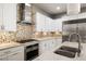 Well-appointed kitchen features stainless steel appliances, mosaic backsplash, and granite countertops at 12125 Edgehurst Ct, Las Vegas, NV 89138