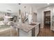 Stylish kitchen island with granite countertops, stainless steel sink, and open floor plan at 12125 Edgehurst Ct, Las Vegas, NV 89138