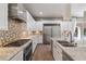 Modern kitchen features stainless steel appliances, a large island with quartz countertops, and ample storage at 12125 Edgehurst Ct, Las Vegas, NV 89138