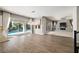 Spacious living area with hardwood floors, a fireplace, and sliding glass doors leading to the pool at 12125 Edgehurst Ct, Las Vegas, NV 89138
