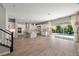 Open floor plan features a chef's kitchen, living area, staircase and sliding glass doors leading to the pool at 12125 Edgehurst Ct, Las Vegas, NV 89138