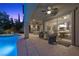 Covered patio view with dining and living area, overlooking a stunning pool and hot tub at 12125 Edgehurst Ct, Las Vegas, NV 89138