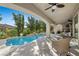 Beautiful pool and spa with mature trees, a covered patio, and outdoor seating, perfect for entertaining at 12125 Edgehurst Ct, Las Vegas, NV 89138